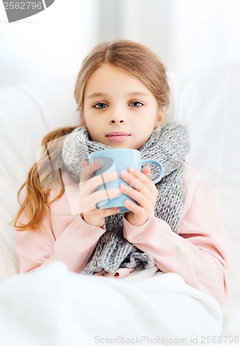 Image of ill girl child with cup of hot tea