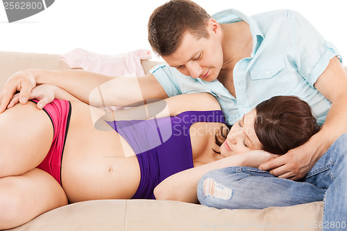 Image of happy expecting parents at home