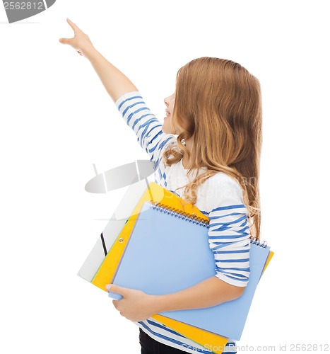 Image of little student girl with notebooks pointing to