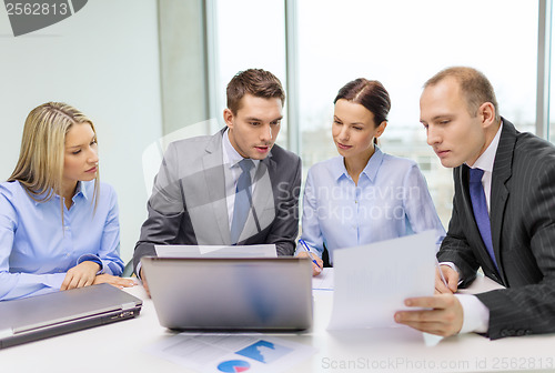 Image of business team with laptop having discussion