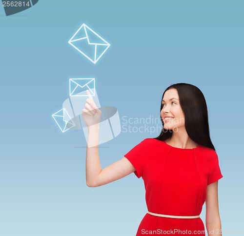 Image of young woman in red dress pointing her finger