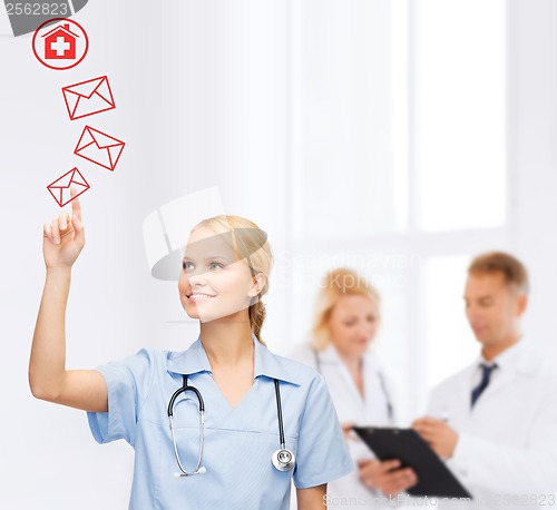 Image of smiling doctor or nurse pointing to envelope