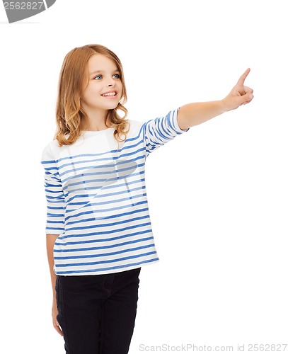 Image of smiling girl pointing at virtual screen