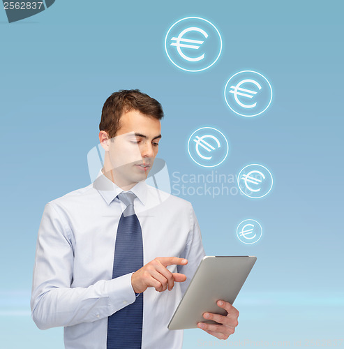 Image of buisnessman with tablet pc and euro icons