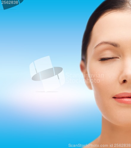 Image of relaxed young woman with closed eyes