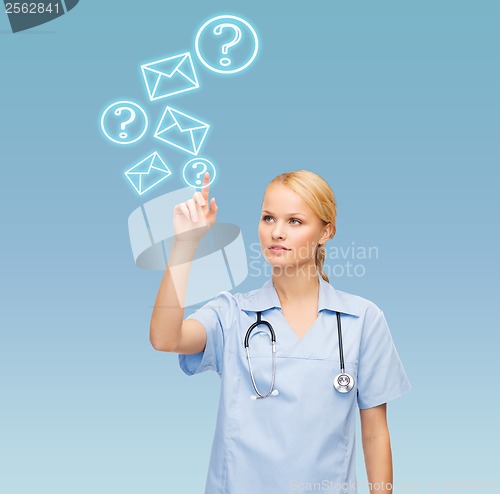 Image of smiling doctor or nurse pointing to something