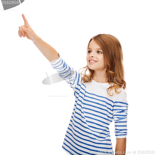 Image of smiling girl pointing at virtual screen