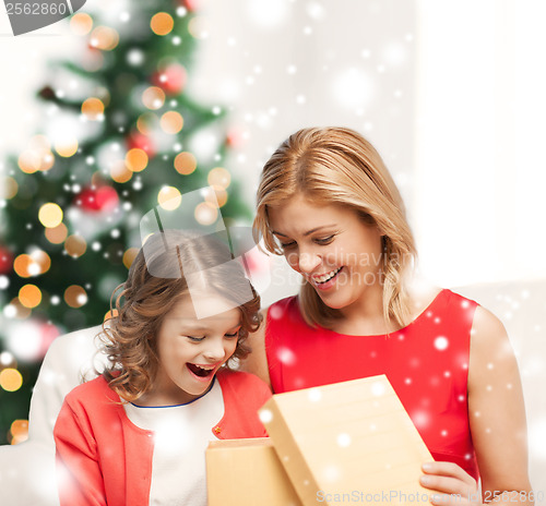 Image of happy mother and child girl with gift box