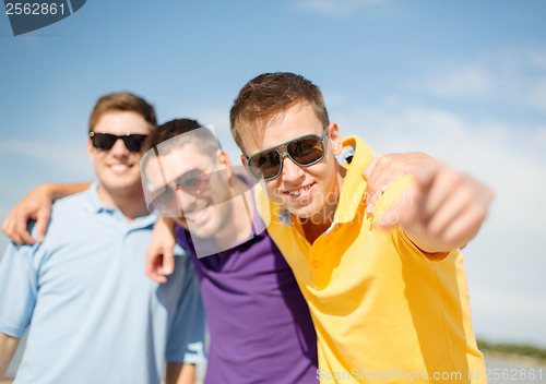 Image of group of friends having fun on the beach