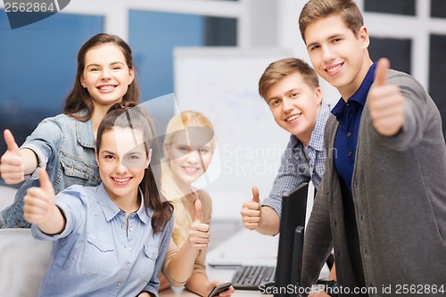 Image of students with computer monitor and smartphones