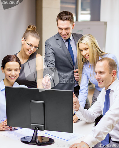 Image of business team with monitor having discussion