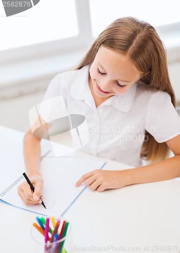 Image of little student girl drawing at school