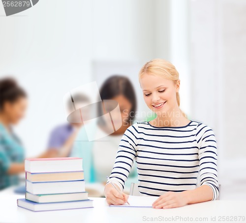 Image of smiling woman studying in college