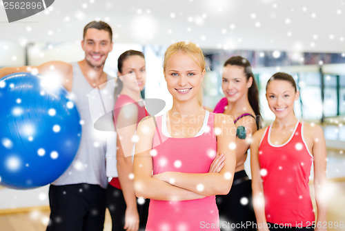 Image of woman standing in front of the group in gym