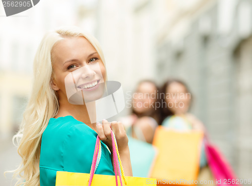 Image of beautiful woman with shopping bags in the ctiy