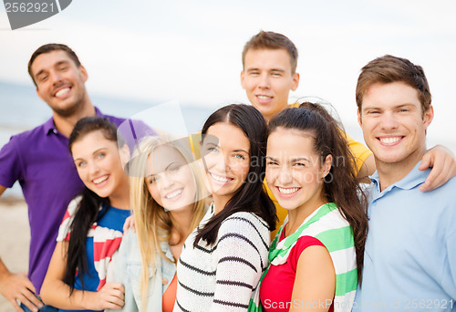 Image of group of friends having fun on the beach