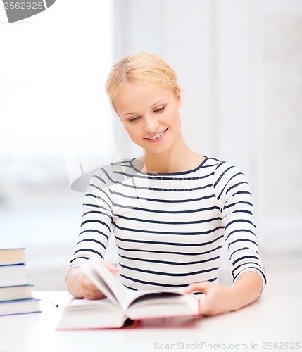 Image of smiling woman studying in college