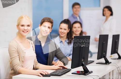 Image of students with computer monitor at school