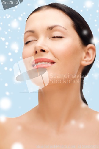 Image of smiling young woman with closed eyes