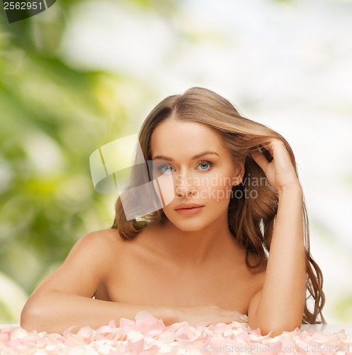 Image of woman with rose petals and long hair