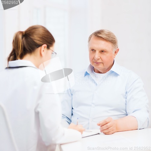 Image of female doctor or nurse with old man prescrbing