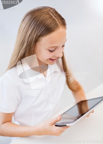 Image of smiling girl with tablet pc at school