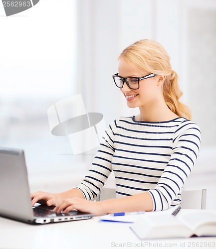 Image of student with laptop computer and eyeglasses