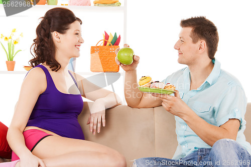 Image of happy expecting parents at home
