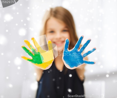 Image of girl showing painted hands