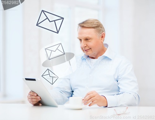 Image of old man with tablet pc computer at home