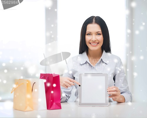 Image of smiling woman with blank screen tablet pc