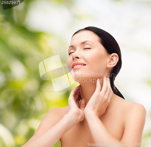 Image of smiling young woman with closed eyes