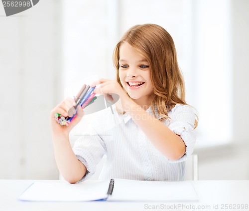 Image of smiling girl choosing colorful felt-tip pen