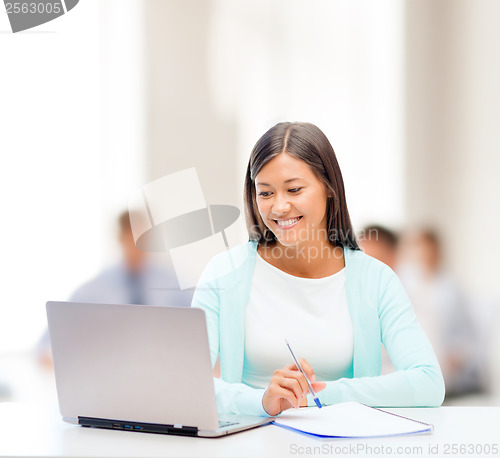 Image of asian businesswoman with laptop and documents