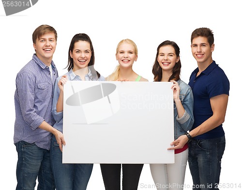 Image of group of standing students with blank white board