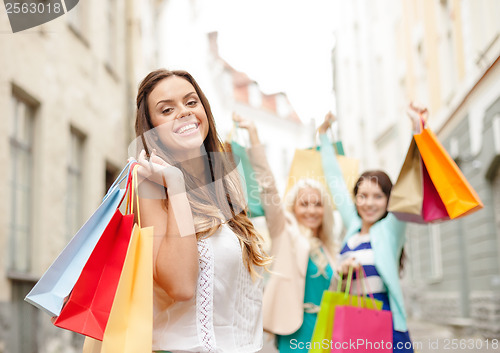 Image of beautiful woman with shopping bags in the ctiy