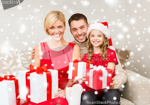 Image of smiling family holding many gift boxes