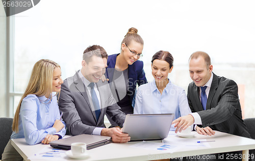 Image of business team with laptop having discussion