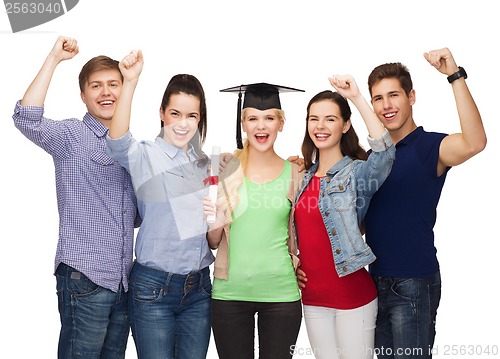 Image of group of standing smiling students with diploma