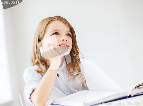 Image of student girl writing in notebook at school