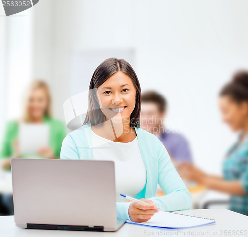 Image of asian businesswoman with laptop and documents