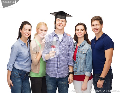 Image of group of standing smiling students with diploma