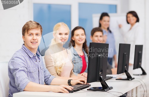 Image of students with computer monitor at school