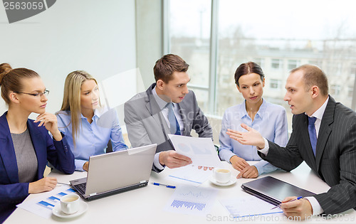 Image of business team with laptop having discussion