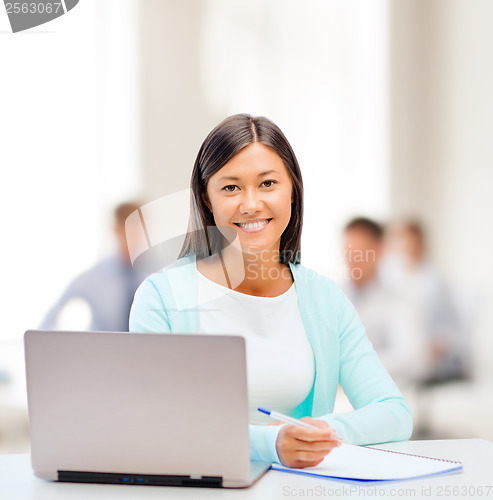 Image of asian businesswoman with laptop and documents