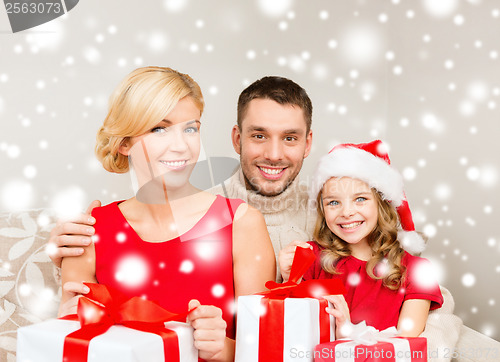 Image of smiling family holding many gift boxes