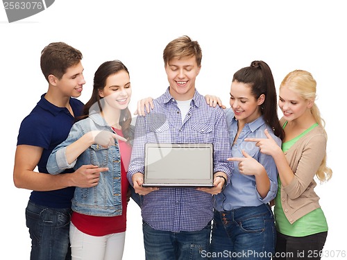 Image of smiling students with laptop computer