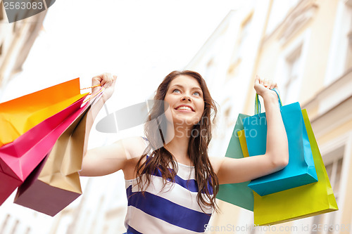 Image of beautiful woman with shopping bags in the ctiy