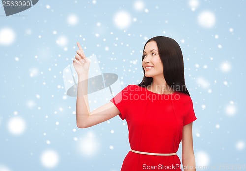 Image of young woman in red dress pointing her finger