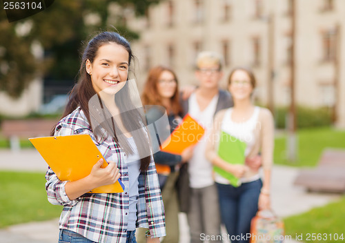 Image of smiling female student with folders